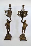 Lote 26 - Par de candelabros patinados a dourado, com guerreiro, 5 lumes, com 68 cm de altura, NOTA: 1 candelabro com peça e mão partida