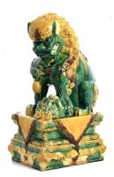 Lote 5189 - Cão de Foo Chinês de grandes dimensões em terracota oriental. Peça bastante invulgar pelo fato da pata esquerda deste cão estar sobre um outro cão e não sobre uma esfera ou outro objecto tal como é comum. Decoração com vidrados em tons de verd