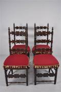 Lote 203 - Conjunto de 4 cadeiras de madeira, espaldar alto de madeira recortada e assento de madeira com almofada estofada em tons de vermelho com berloques, usado