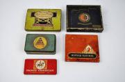 Lote 1870199 - Lote de 5 caixas antigas de cigarrilhas sendo 4 em lata e 1 em cartão, com tamanhos entre 14x14 cm e 6x12 cm, com falhas e sinais de ferrugem e caixa para cigarros em porcelana e tampa em madeira, com 13,5x8 cm, usada