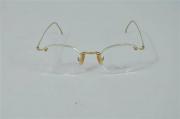 Lote 356 - Armações de óculos Calvin Klein em metal dourado, modelo oval Nota: como novo