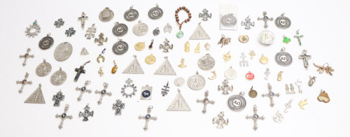 Lote 45 - PENDENTES - Coleção com aprox. 100 pendentes, amuletos e medalhas em metal prateado e dourado, esmaltes, madeira e madrepérola entre outros materiais, com decorações, tamanhos e motivos variados, sendo de temas como religião, politica, publicitá