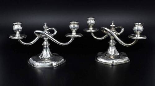 Lote 2684 - Par de Candelabros de Dois Lumes em Prata Portuguesa, com marca de contraste Águia de Lisboa (1938-1985) e com o peso total em Prata de 1484 gr e 28 cm de diâmetro. Candelabros com profusa decoração cinzelada. Trabalho cuidado de decoração e c