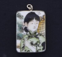 Lote 119 - PENDENTE ORIENTAL - Placa em porcelana com decoração policromada com "figura feminina", com aro e argola em metal prateado. Dim: 40x30 mm