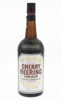 Lote 75 - LICOR PETER HEERING - Garrafa de Licor, Cherry Heering, Peter F. Heering, Dinamarca, (700ml - 24,7%vol.). Nota: garrafa antiga, invólucro da rolha violado