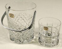 Lote 77 - BALDE DE GELO E COPO DE WHISKY EM CRISTAL ATLANTIS - ambos com decoração estriada formando motivos geométricos, com autocolante original do fabricante, balde com pega em metal prateado. Mínimos sinais de uso. Altura do balde: 14,2 cm