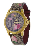 Lote 2 - GUCCI, RELÓGIO DE PULSO DE SENHORA - Modelo Ref. 126.4 .Caixa em aço dourado com 38 mm e bracelete em pele e tecido. Movimento de quartzo. Mostrador com decoração floral e aplicação de borboleta. Relógio idêntico à venda por € 845. Nota: a funcio