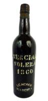 Lote 1992 - Garrafa de Vinho da Madeira Leacocks Sercial Solera de 1860. Atinge valores de venda em garrafeiras internacionais de 1190€ (http://www.sodivin.co.uk) Nota: com perda aceitável para idade da garrafa em questão